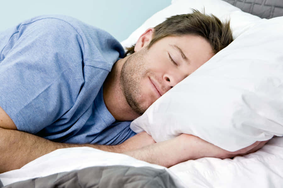 Man In A Blue Shirt Sleeping Wallpaper