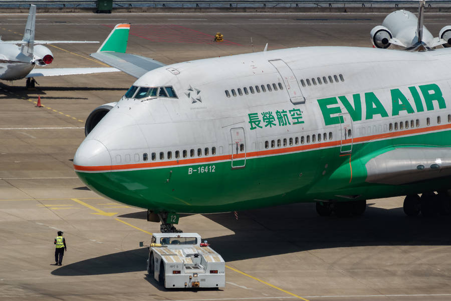 Man Infront Of Eva Air Wallpaper