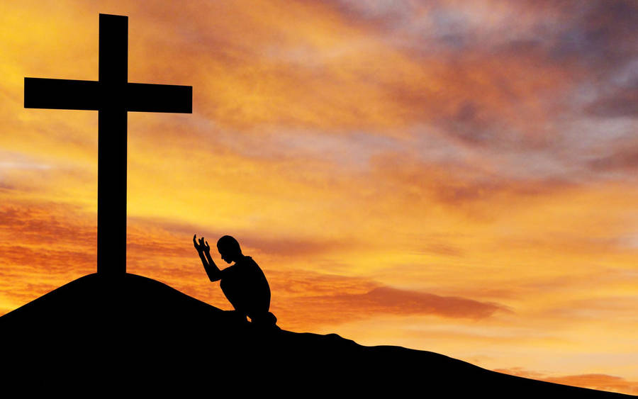 Man Praying To Cross Of The Christian God Wallpaper