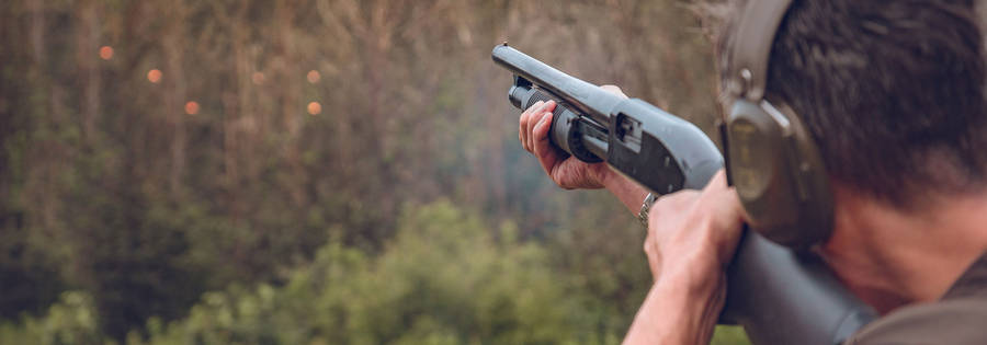 Man Shooting A Long Rifle Close-up Wallpaper