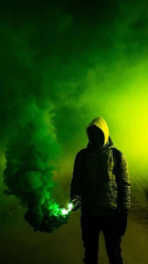 Man Silhouetted Against Green Smoke Explosion Wallpaper