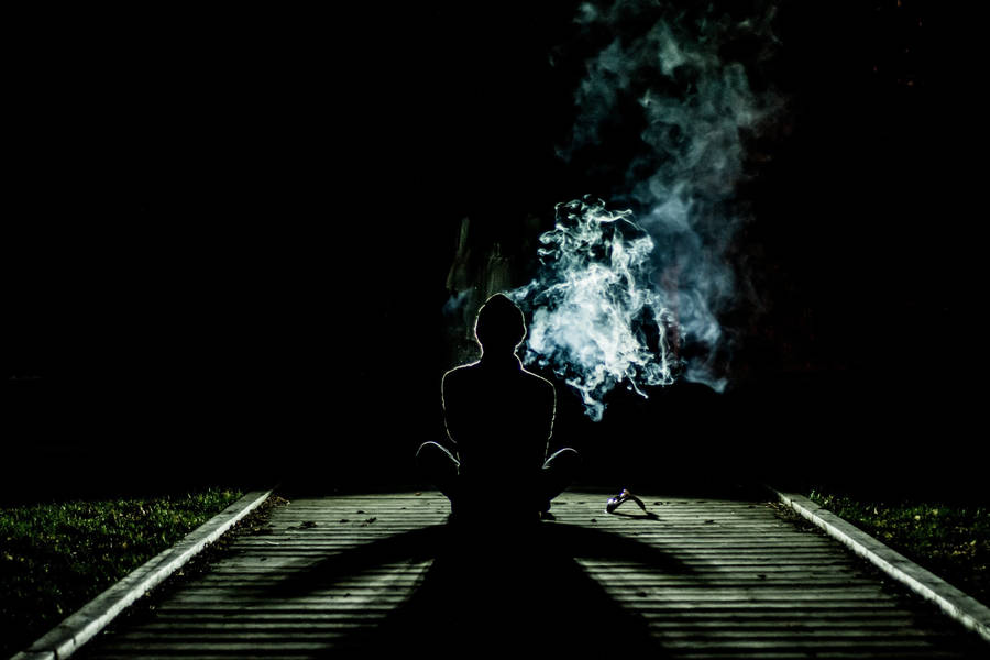 Man Smoking On Pathway Alone Phone Wallpaper