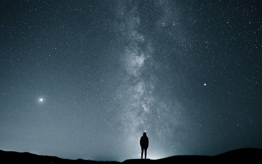 Man Stargazing Alone Wallpaper