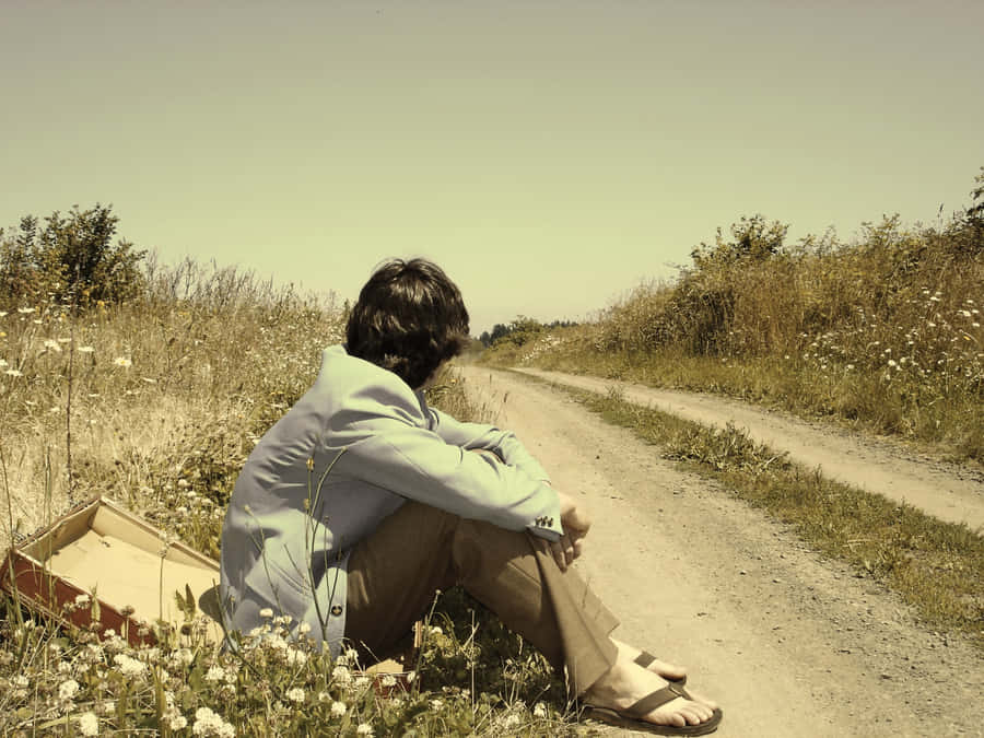 Man Waiting Under The Striking Sun Wallpaper