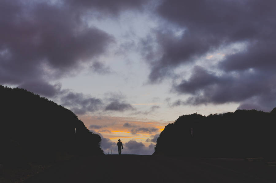 Man Walks Near Rocks Wallpaper