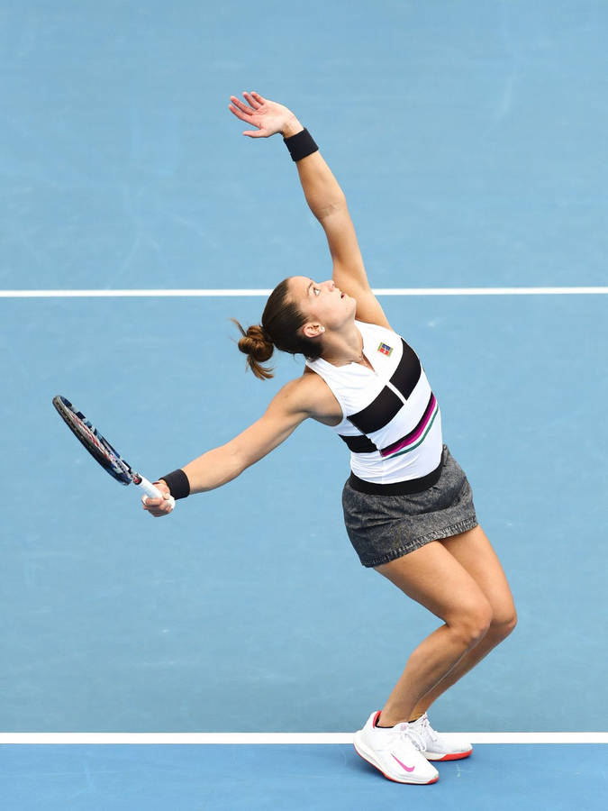 Maria Sakkari Hitting Tennis Ball To Serve Wallpaper