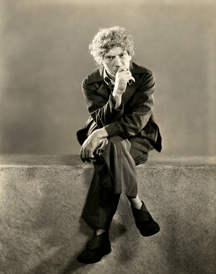 Marx Brothers Harpo Marx Sitting On Ledge Wallpaper