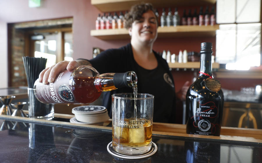 Master Bartender Refilling At Black Button Distilling Wallpaper