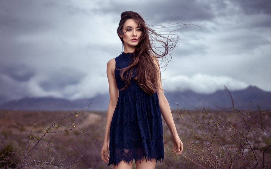 Mature Woman In The Stormy Desert Wallpaper