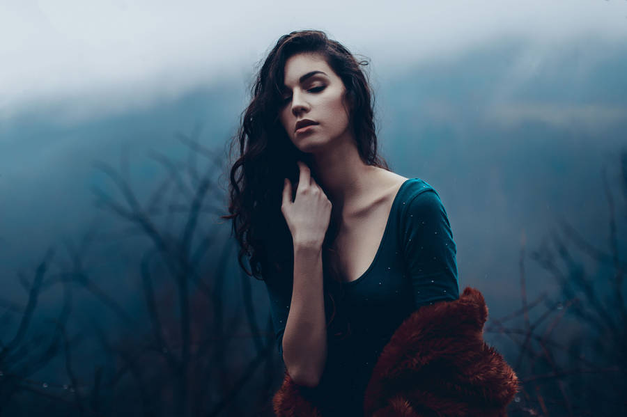 Mature Woman Posing By A Dark Forest Wallpaper