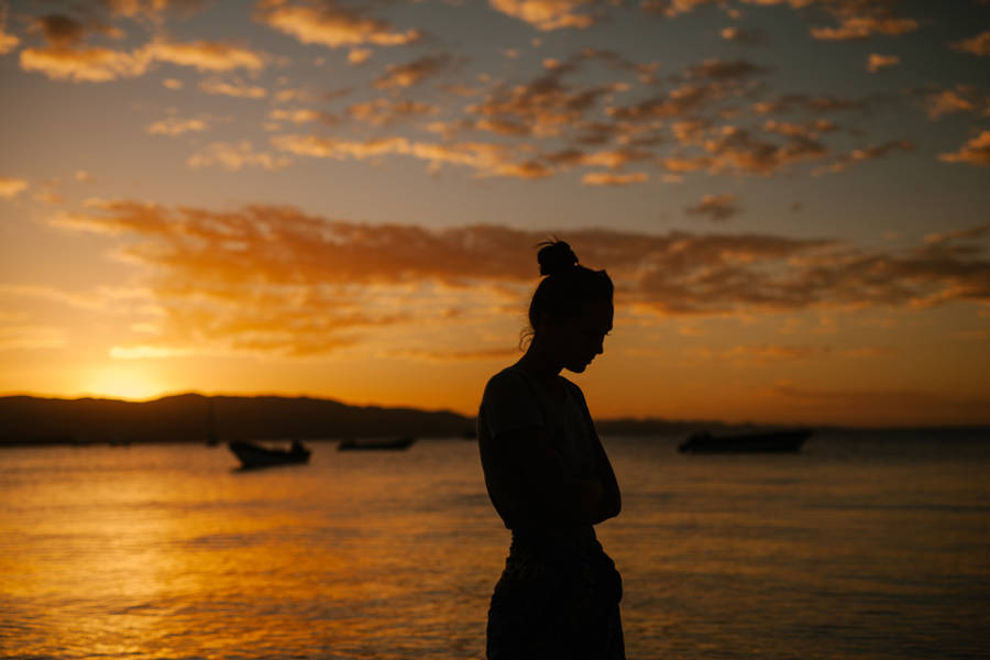 Melancholic Dusk: A Woman Reflecting By The Sea Wallpaper