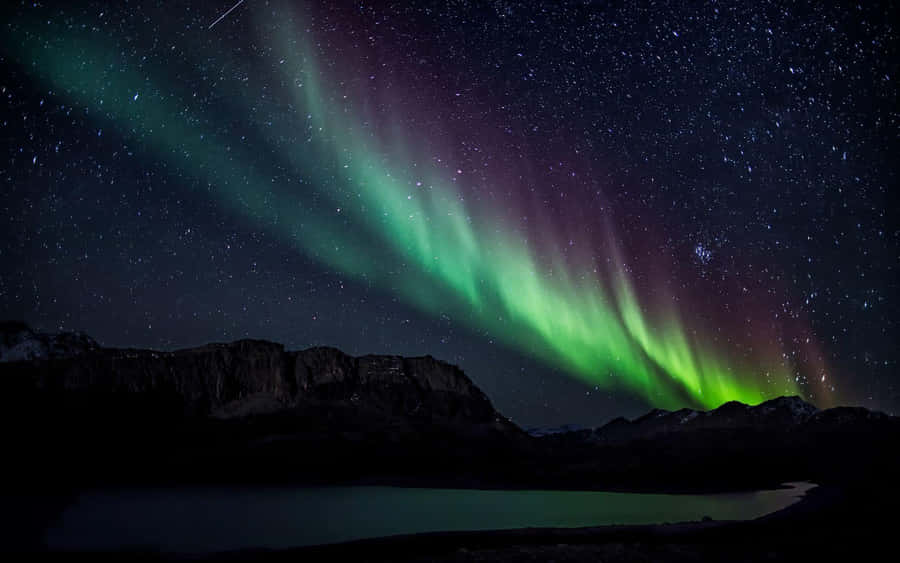 Mesmerizing Aurora Borealis Dancing In The Night Sky Wallpaper