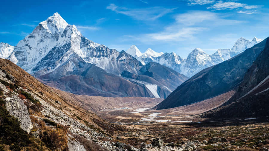 Mesmerizing Mountain With Clouds Rolling In Wallpaper