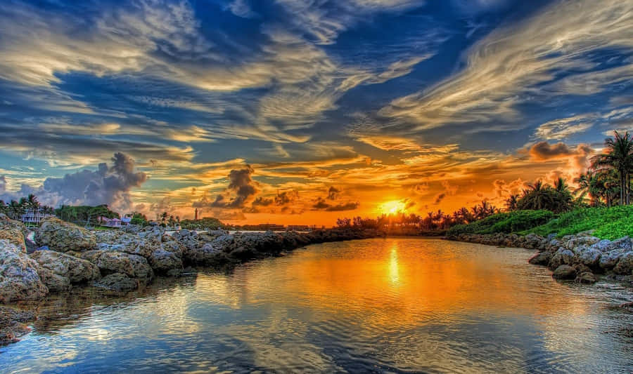 Mesmerizing Sunrise At A Serene Lake Wallpaper