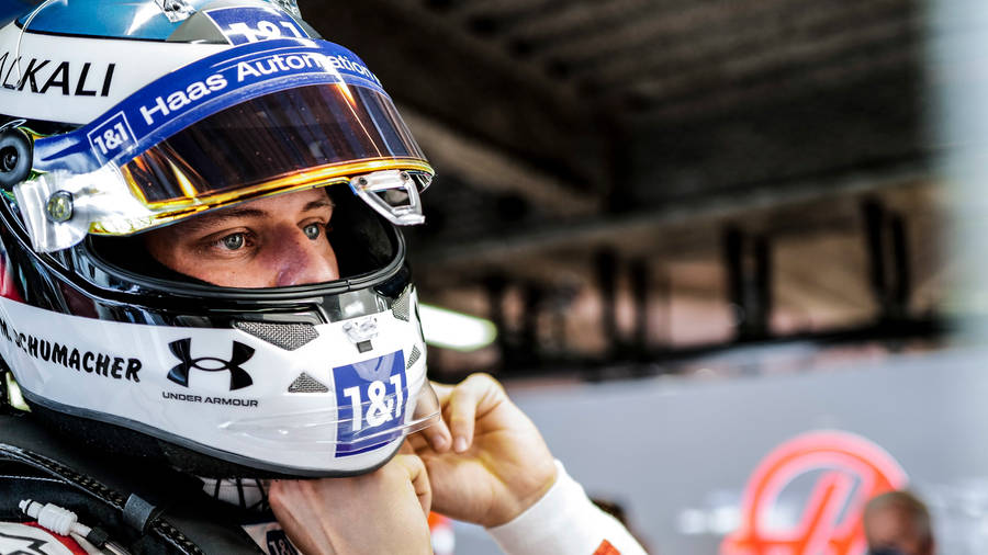 Mick Schumacher Securing His Helmet Wallpaper