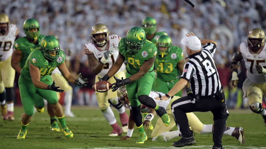 Mighty Oregon Ducks Football Team In Action Wallpaper