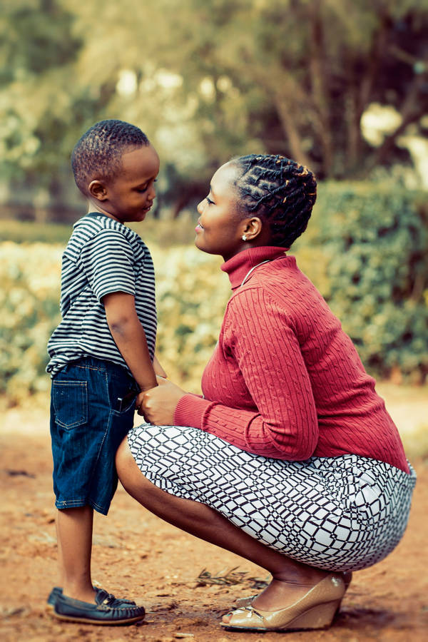 Mom And Son Facing Each Other Wallpaper