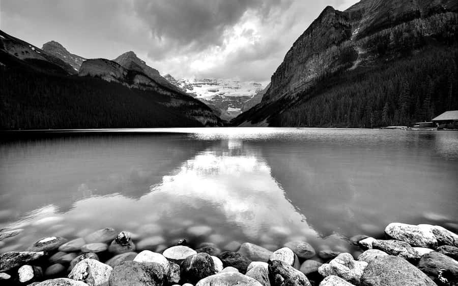 Monochrome Mountain Lake With Rocks Wallpaper