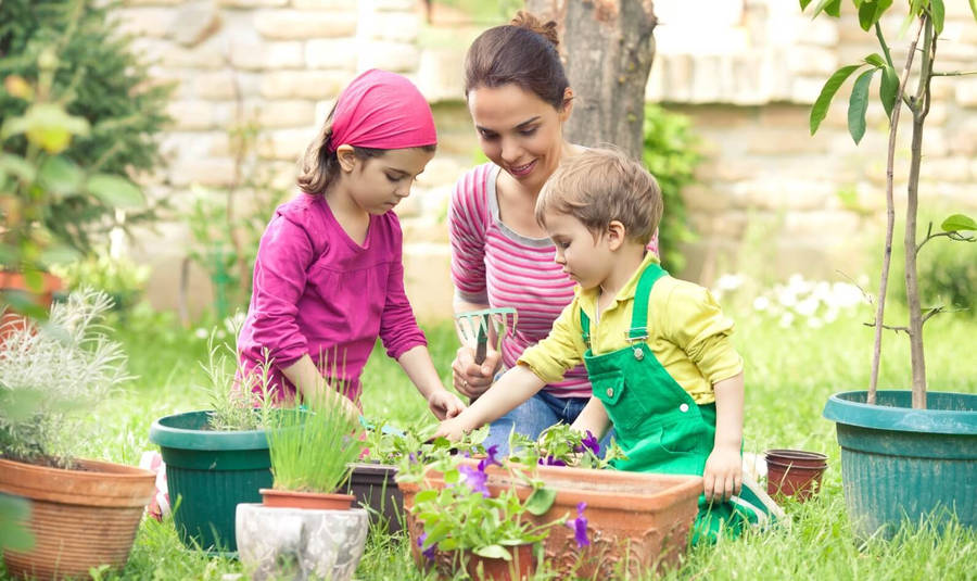 Mother And Children Gardening Wallpaper