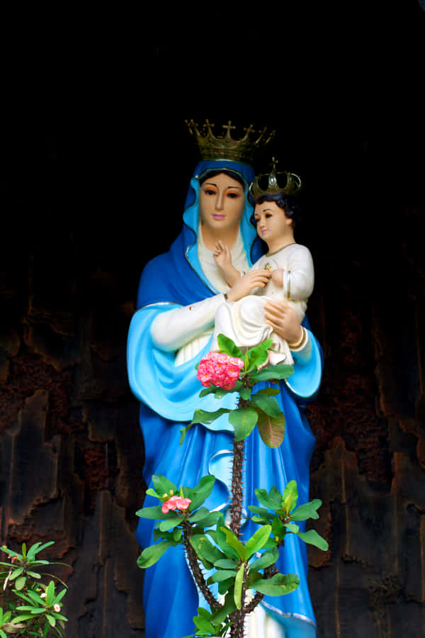 Mother Mary Holding The Holy Child Jesus In Her Loving Embrace Wallpaper