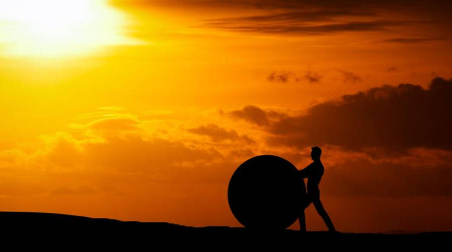 Motivation Man Pushing A Rock Sphere Wallpaper