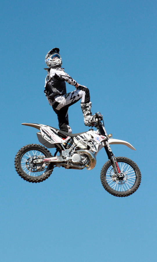 Motocross Rider Kneeling Jump Wallpaper