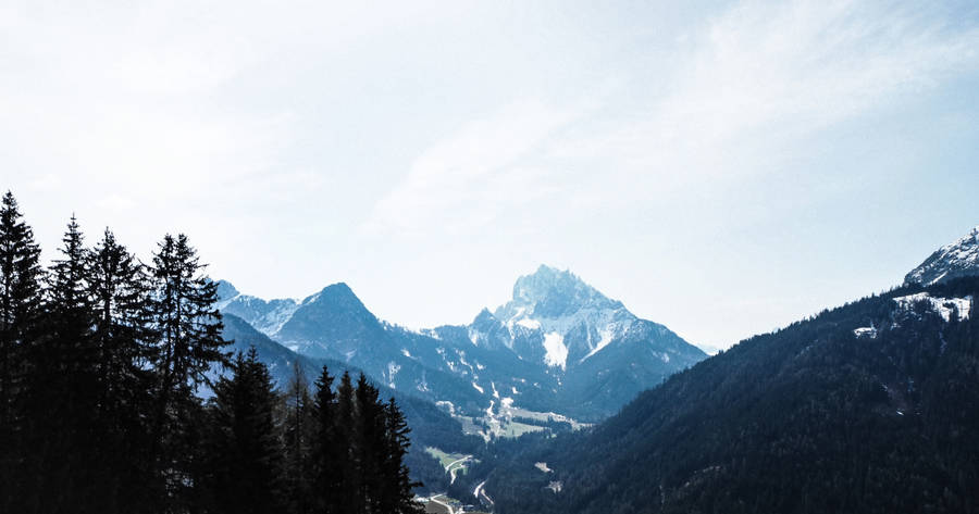 Mountains Under A Beautiful Blue Sky Wallpaper