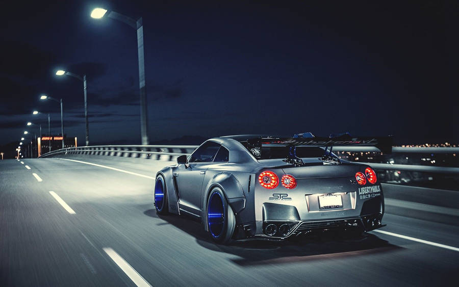 Moving Silver Nissan Gtr Along The Road Wallpaper