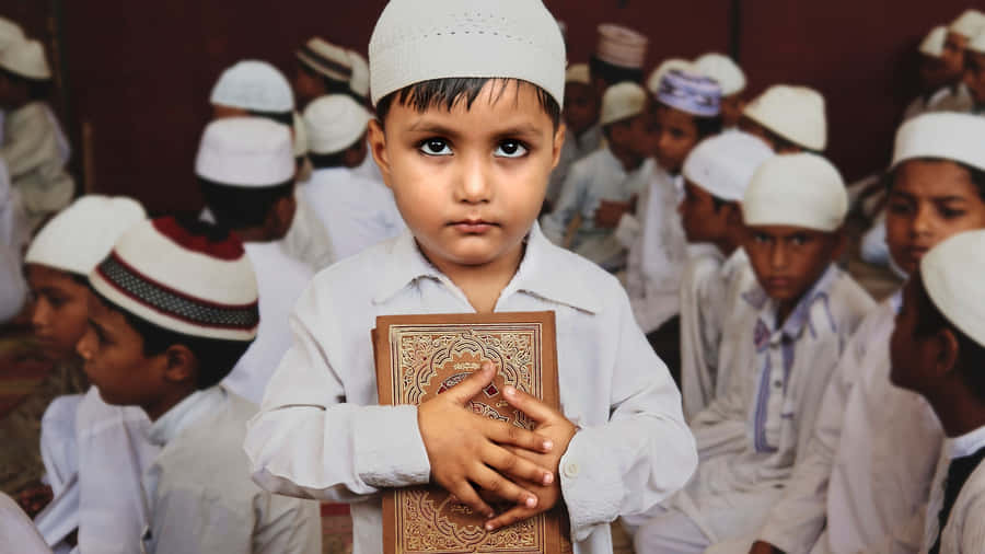 Muslim Boy Hugging Quran Wallpaper