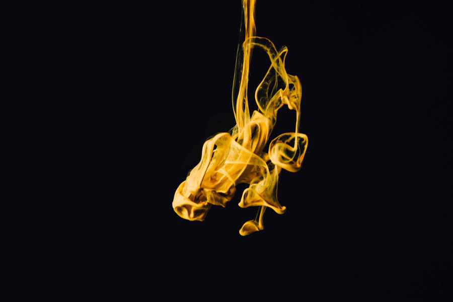 Mysterious Yellow Volatile Substance Against A Dark Background Wallpaper