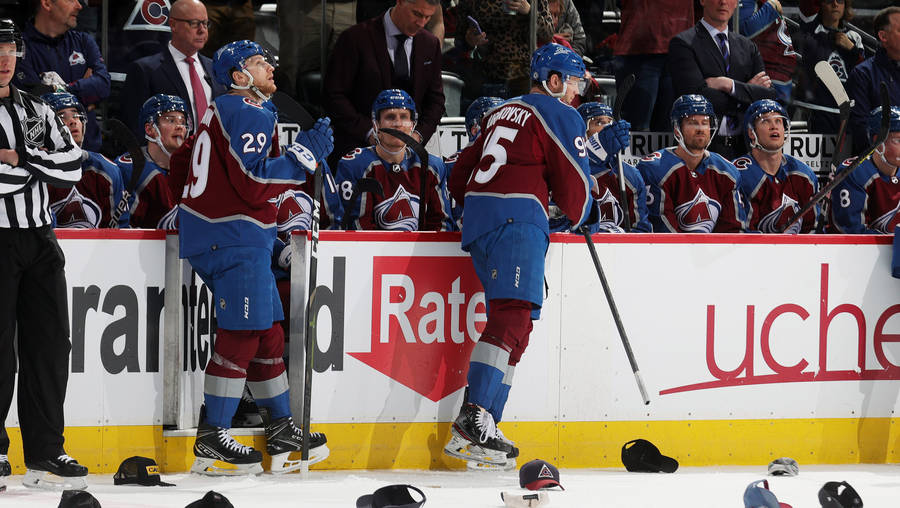 Nathan Mackinnon With Teammates In Intense Discussion During Game Wallpaper