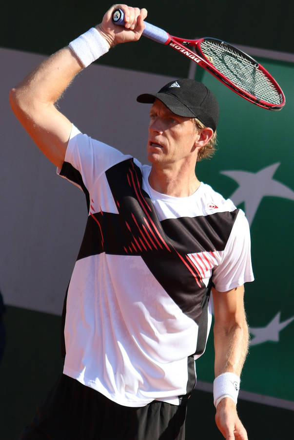 National Tennis Champion, Kevin Anderson, Poised For Action In-game With His Fierce Red Tennis Racket. Wallpaper