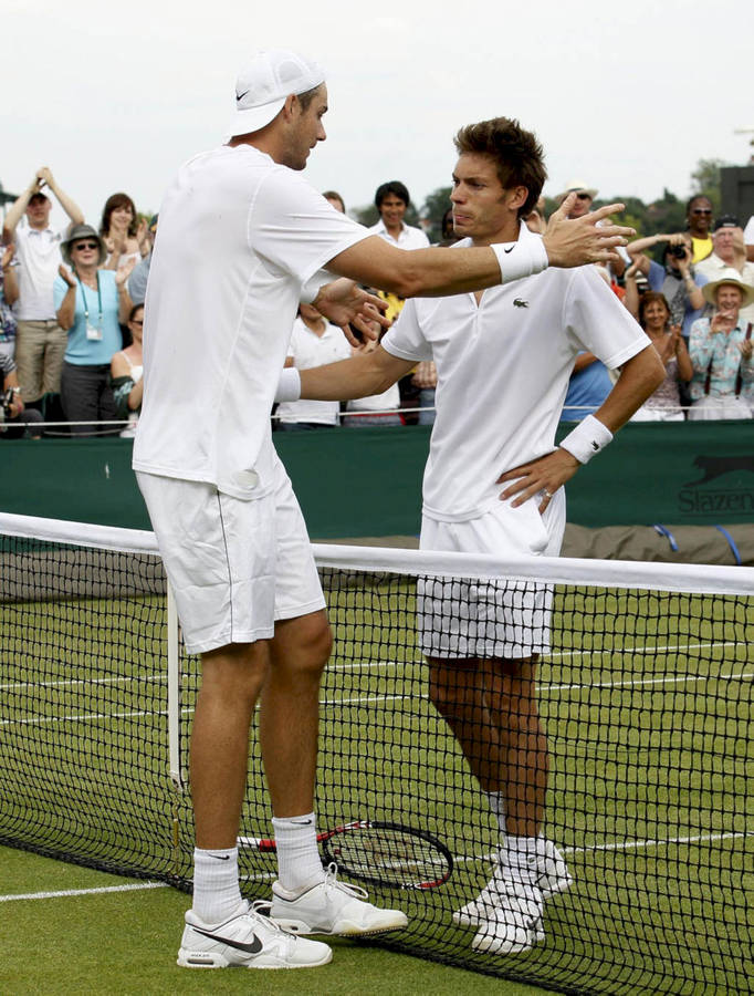 Nicolas Mahut And John Isner Embrace After Feature Match Wallpaper