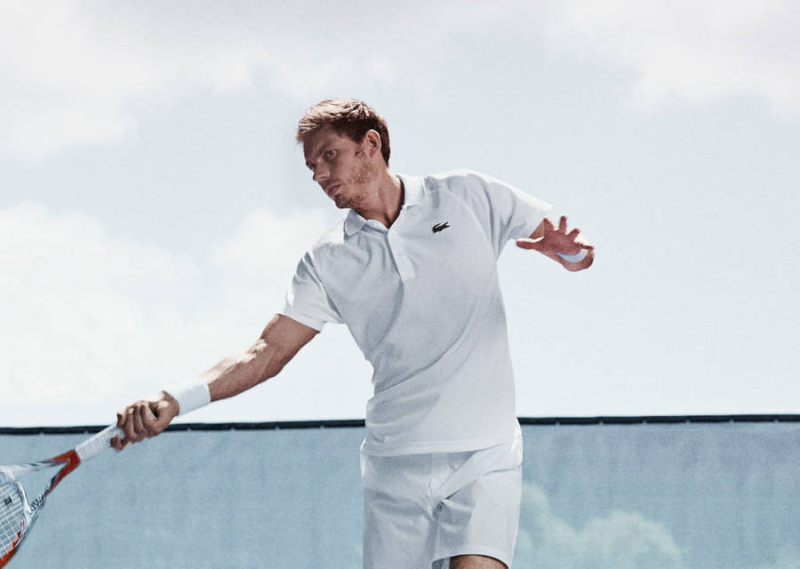 Nicolas Mahut Donned In Lacoste Sportswear, Displaying A Perfect Pose With His Tennis Racquet. Wallpaper