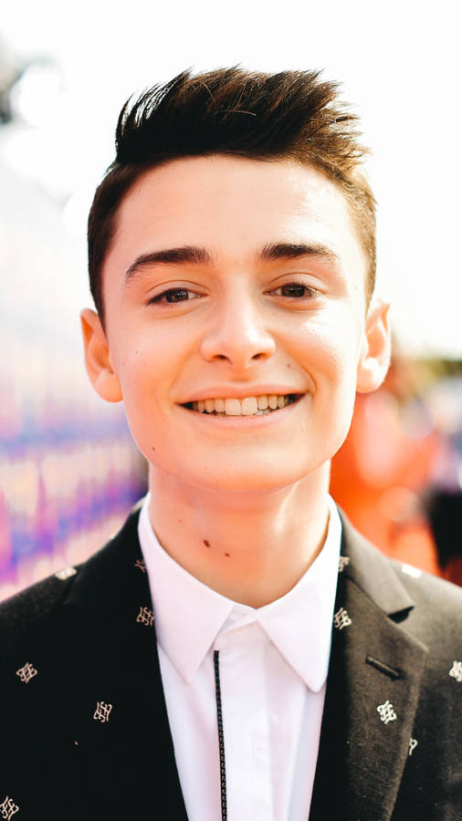 Noah Schnapp Smiling For Phone Background Wallpaper