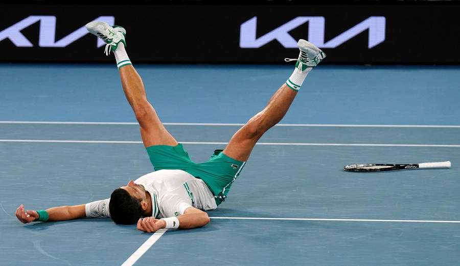 Novak Laying On Australian Open Court Wallpaper