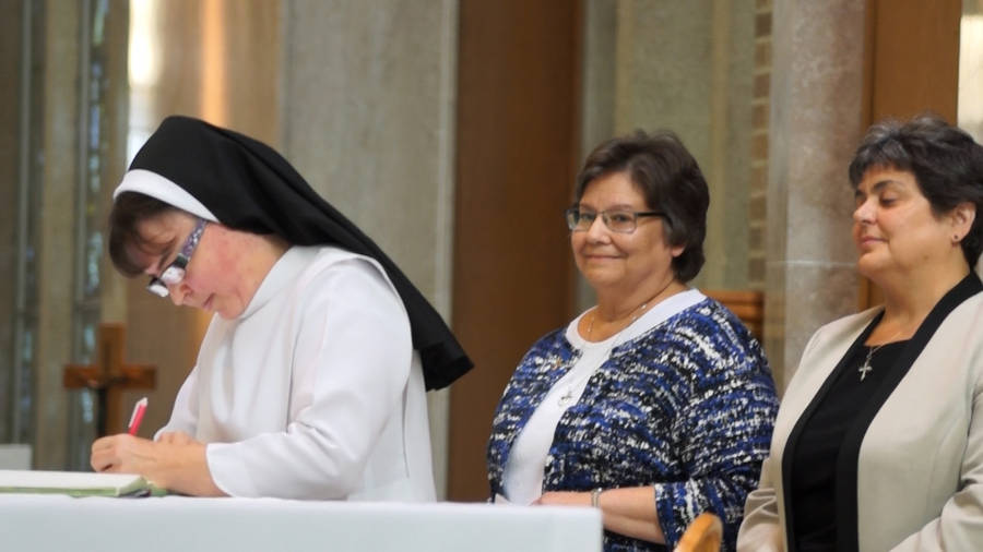 Nun Signing With Two Women Wallpaper