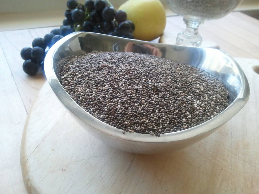 Nutritious Chia Seeds In A Metallic Container Wallpaper