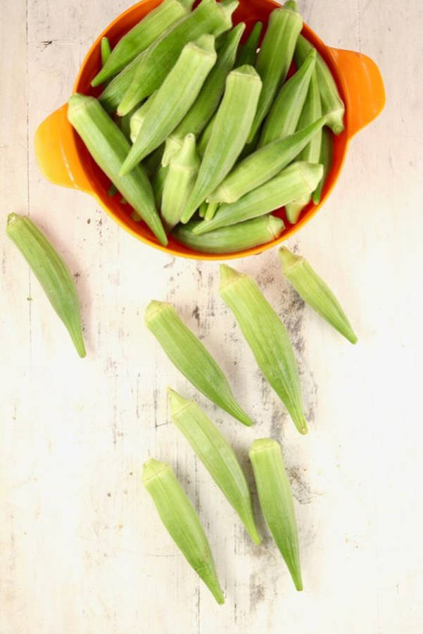 Okra Vegetables In Orange Bowl Wallpaper