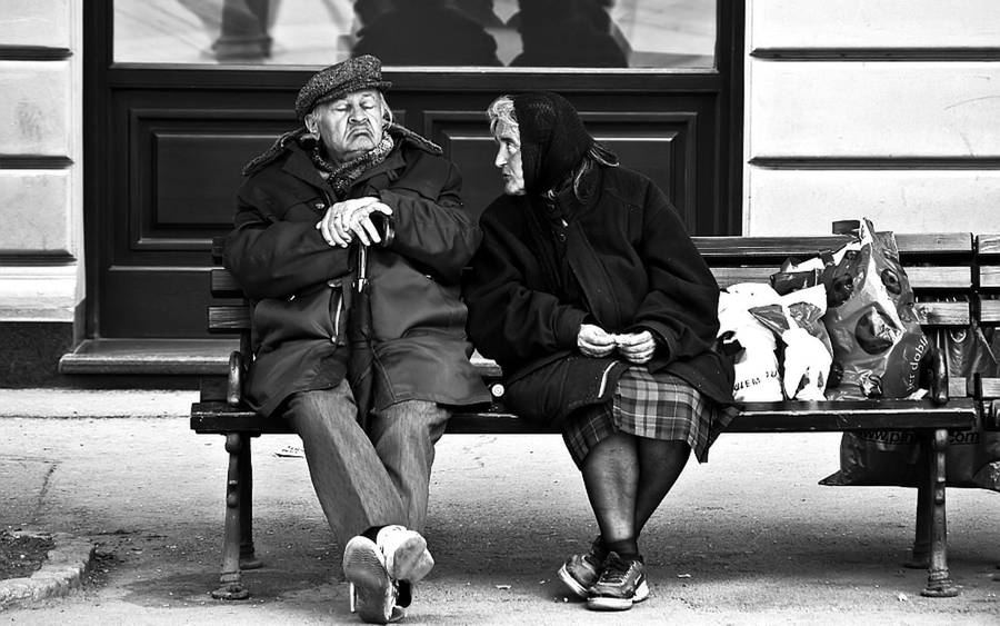 Old Woman And Man In The Waiting Station Wallpaper