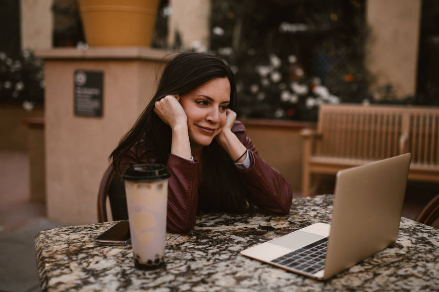 Older Woman Smiling At The Laptop Wallpaper