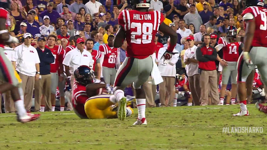 Ole Miss Football Intense Playing Wallpaper