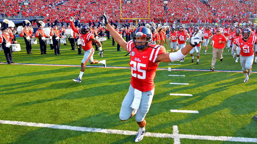 Ole Miss Player Running On Field Wallpaper