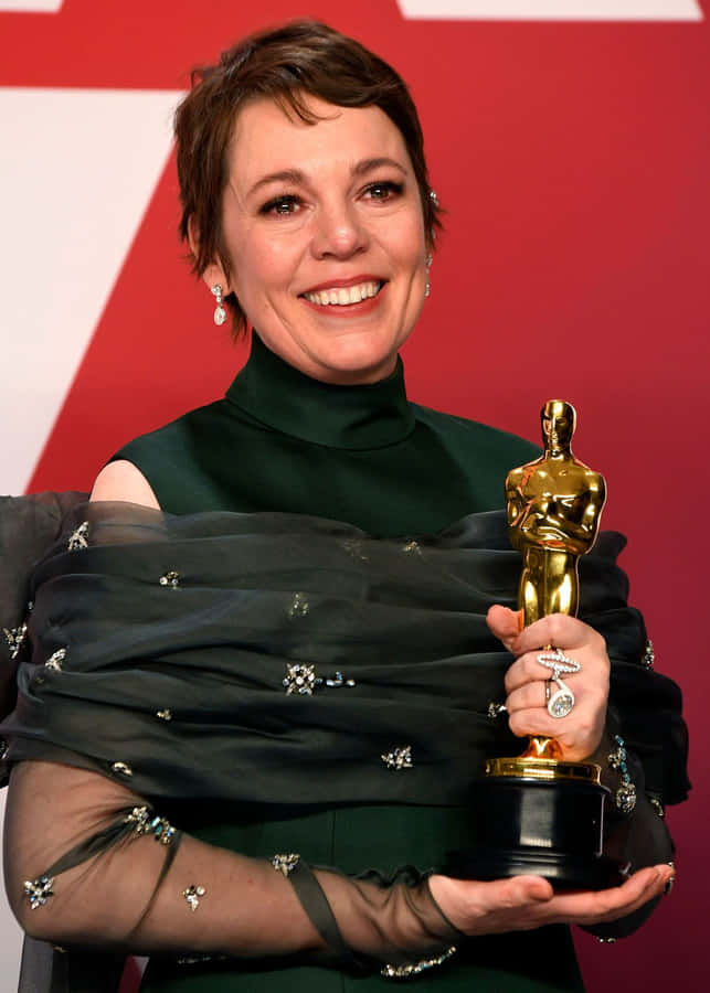 Olivia Colman Striking An Elegant Pose Wallpaper