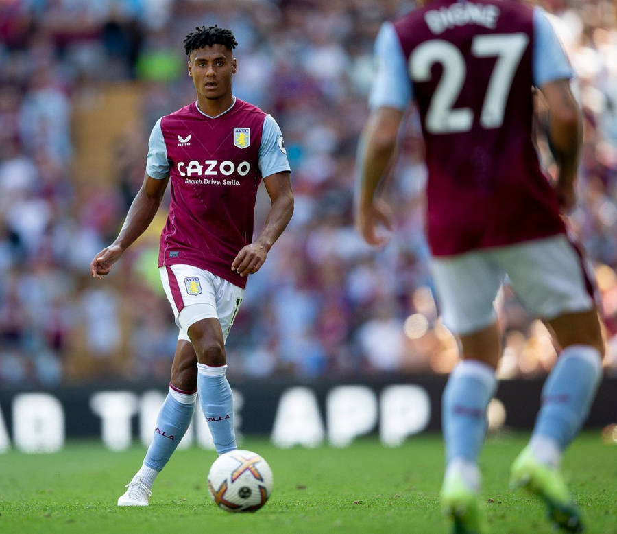 Ollie Watkins Handling The Ball In A Football Match Wallpaper