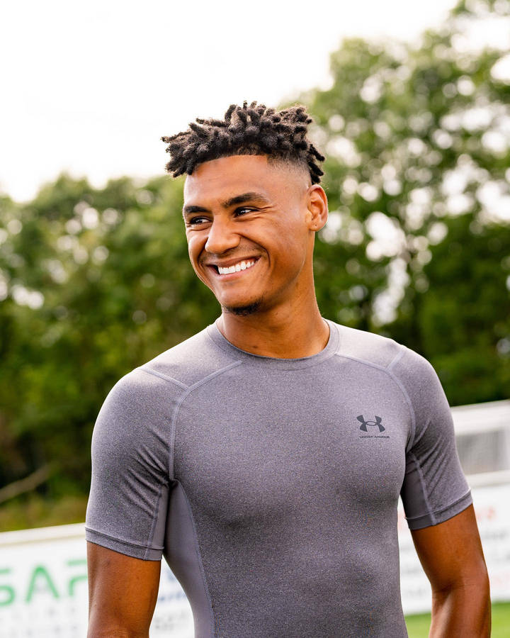 Ollie Watkins Sporting A Trendy Grey Shirt Wallpaper