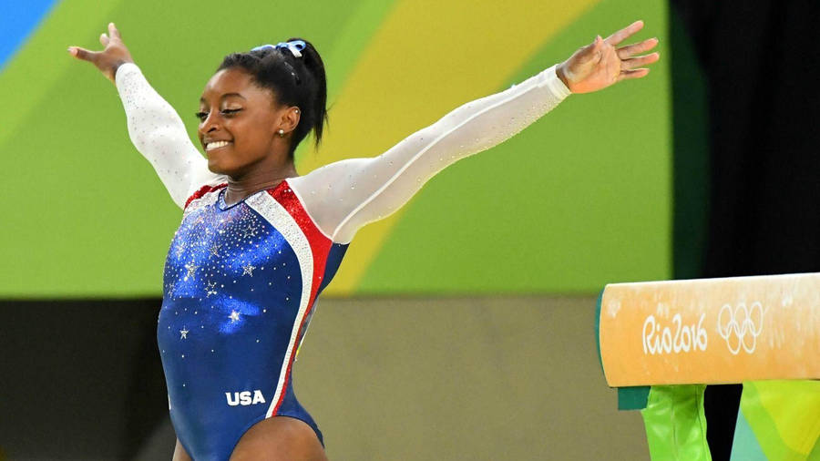 Olympian Simone Biles Arms Out Wallpaper