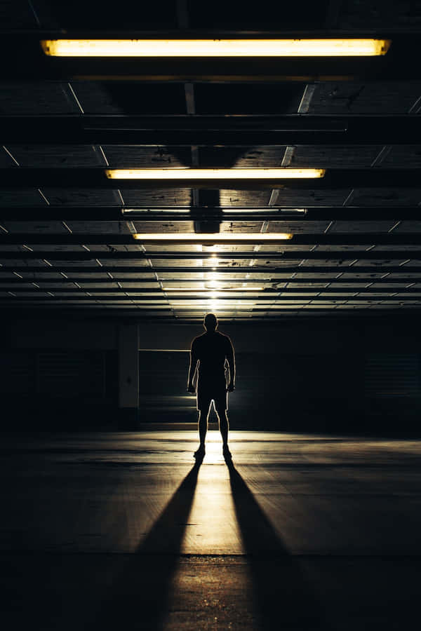 Ominous Man Against The Light Wallpaper