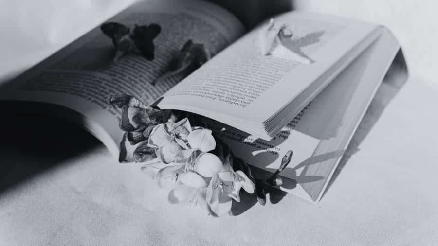 Open Bookwith Dried Flowers Blackand White Wallpaper