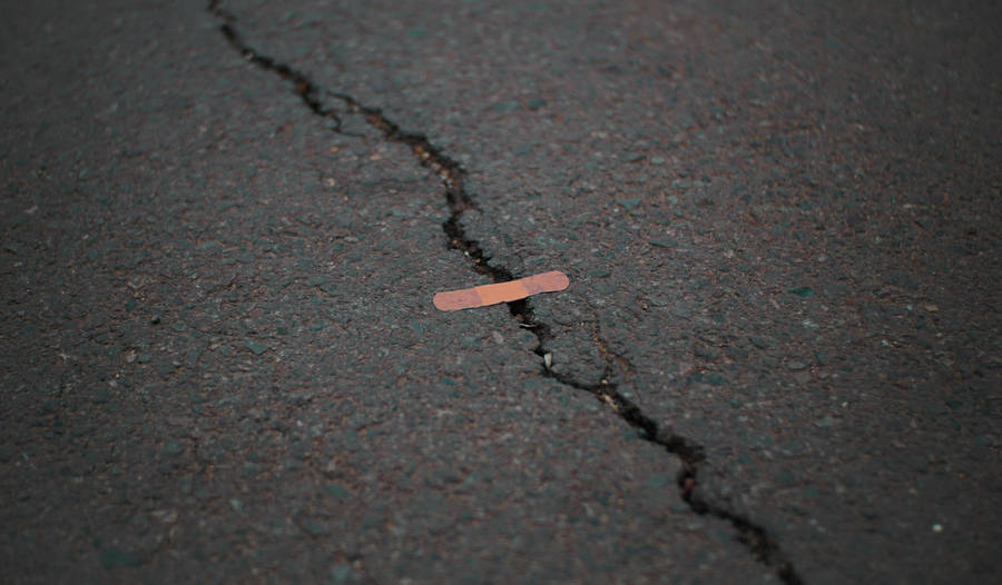 Orange Band Aid On Concrete Surface Crack Wallpaper